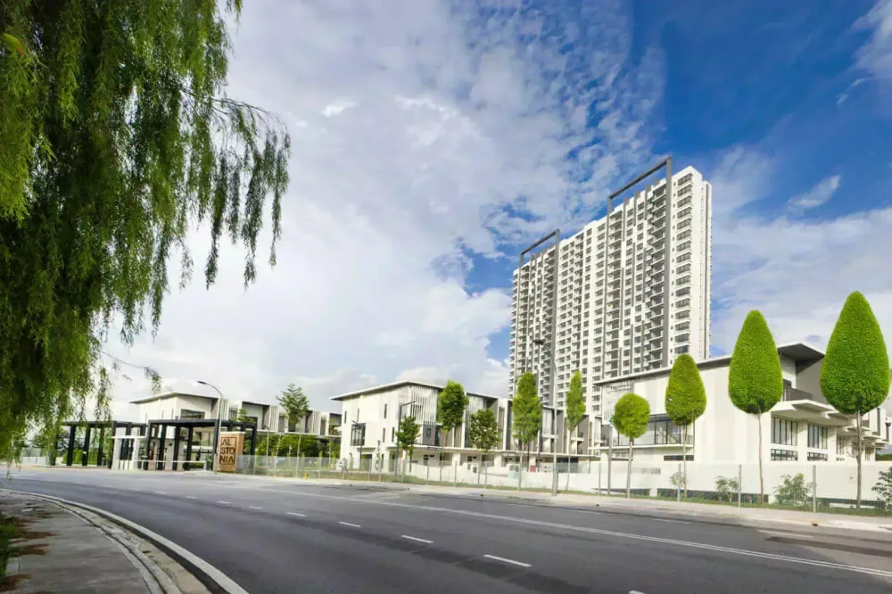 Alstonia main entrance streetscape with the condominium tower and villas